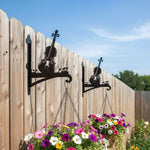 Vintage violin metal hanging basket bracket mounted on outdoor wall for plant decoration
