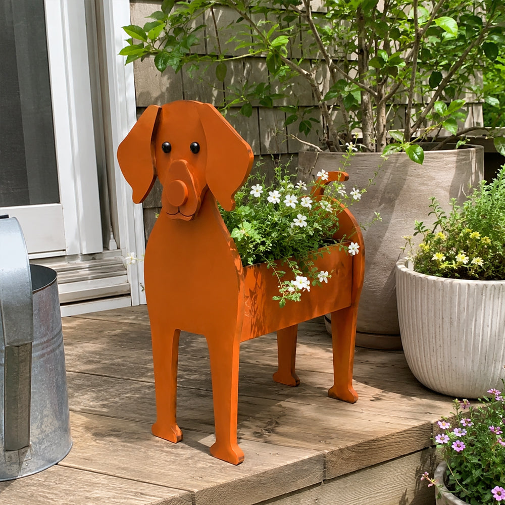 Vizsla dog planter filled with fresh flowers is placed in the garden