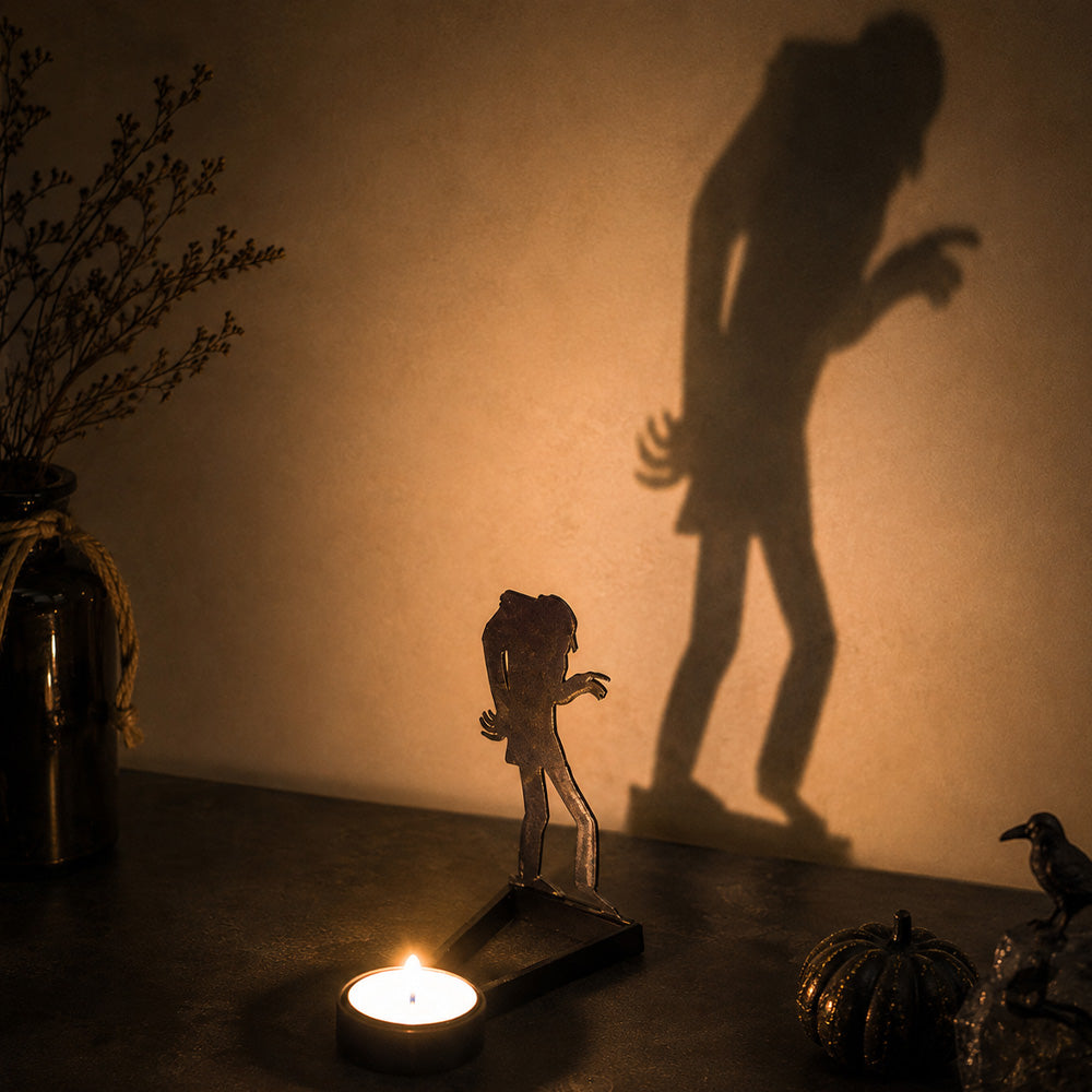 Walking zombie halloween metal candle holder casting a spooky shadow on the wall