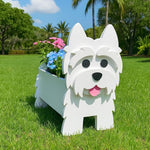 West Highland White Terrier dog planter filled with fresh flowers is placed in the garden