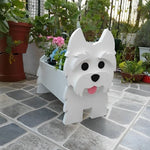 West Highland White Terrier dog planter filled with fresh flowers is placed in the garden