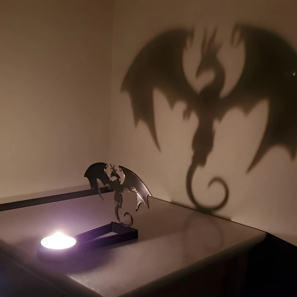 Winged dragon halloween metal candle holder casting a spooky shadow on the wall