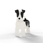 Wire Fox Terrier dog planter filled with fresh flowers is placed in the garden