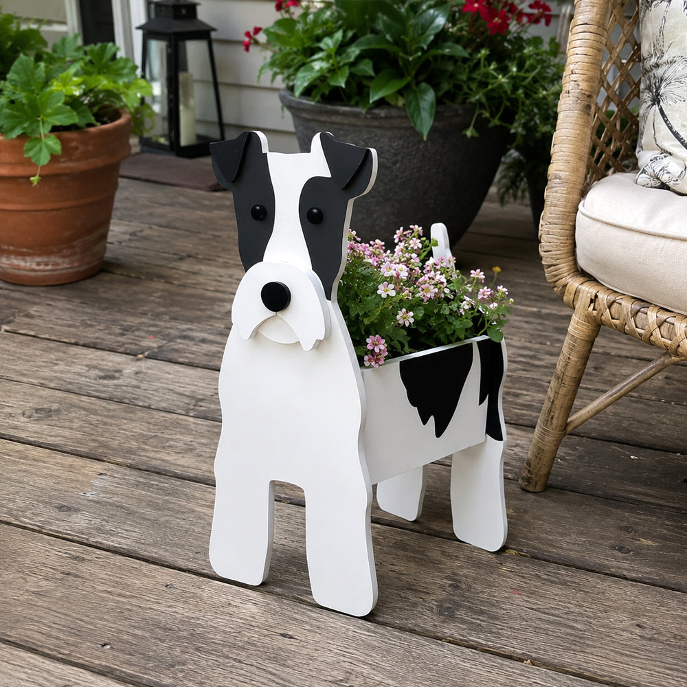 Wire Fox Terrier dog planter filled with fresh flowers is placed in the garden