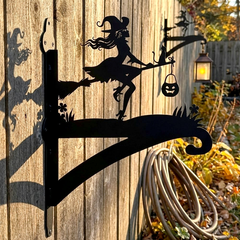 Witch and black cat metal hanging basket bracket mounted on outdoor wall for plant decoration