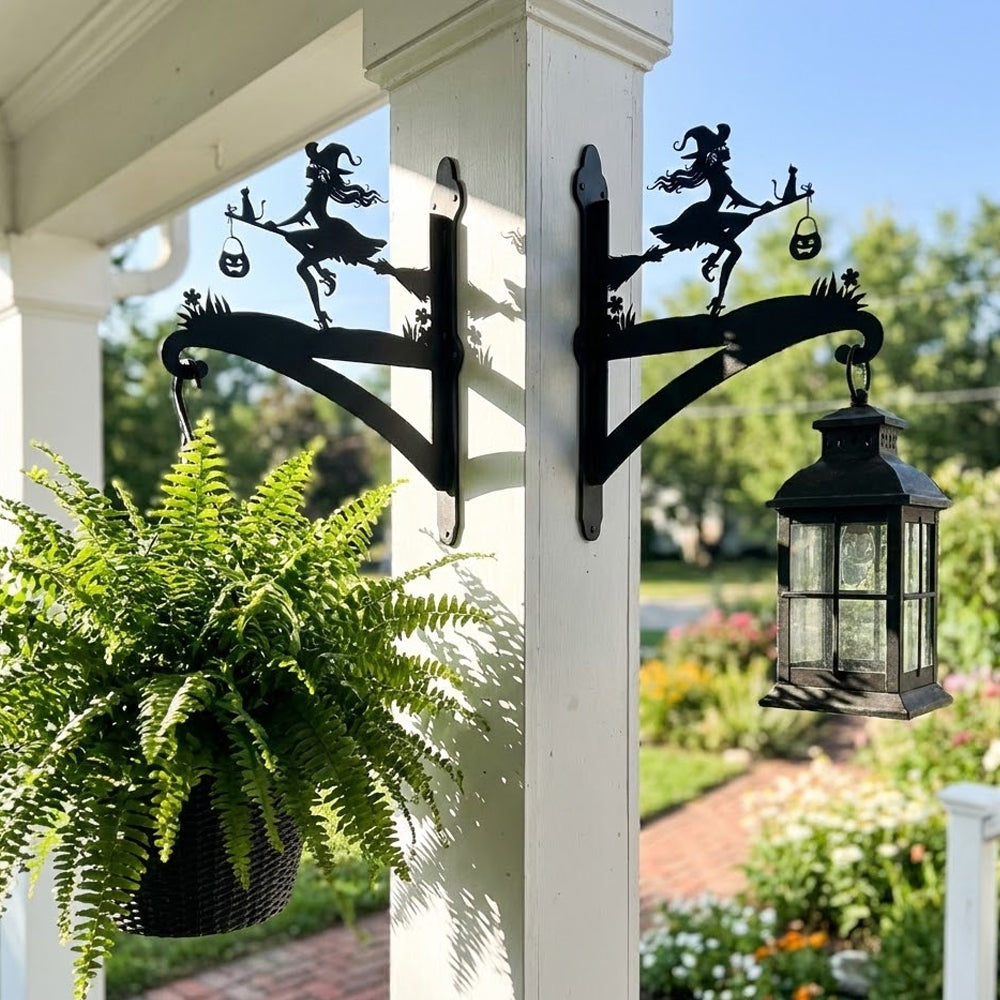 Witch and black cat metal hanging basket bracket mounted on outdoor wall for plant decoration