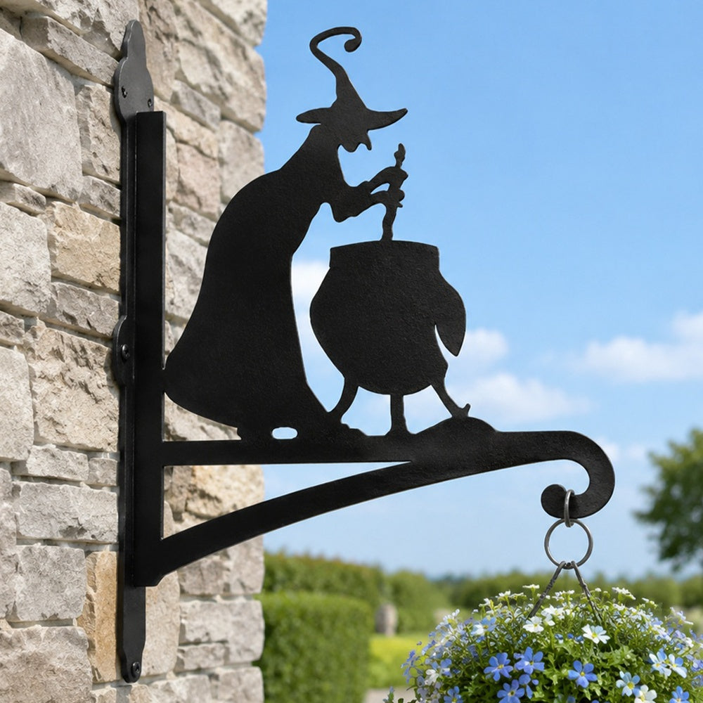 Witch and cauldron metal hanging basket bracket mounted on outdoor wall for plant decoration