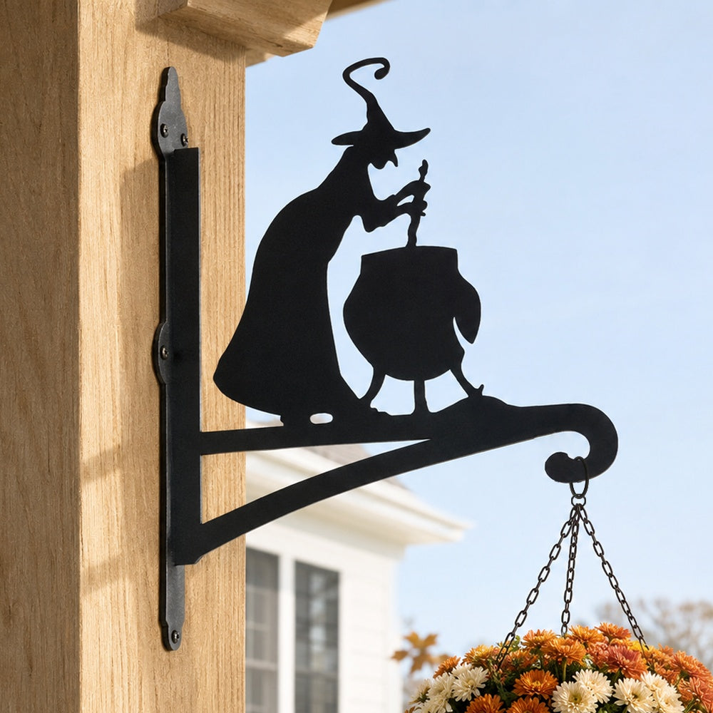 Witch and cauldron metal hanging basket bracket mounted on outdoor wall for plant decoration