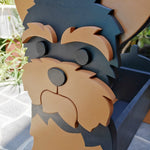 Yorkshire Terrier dog planter filled with fresh flowers is placed in the garden