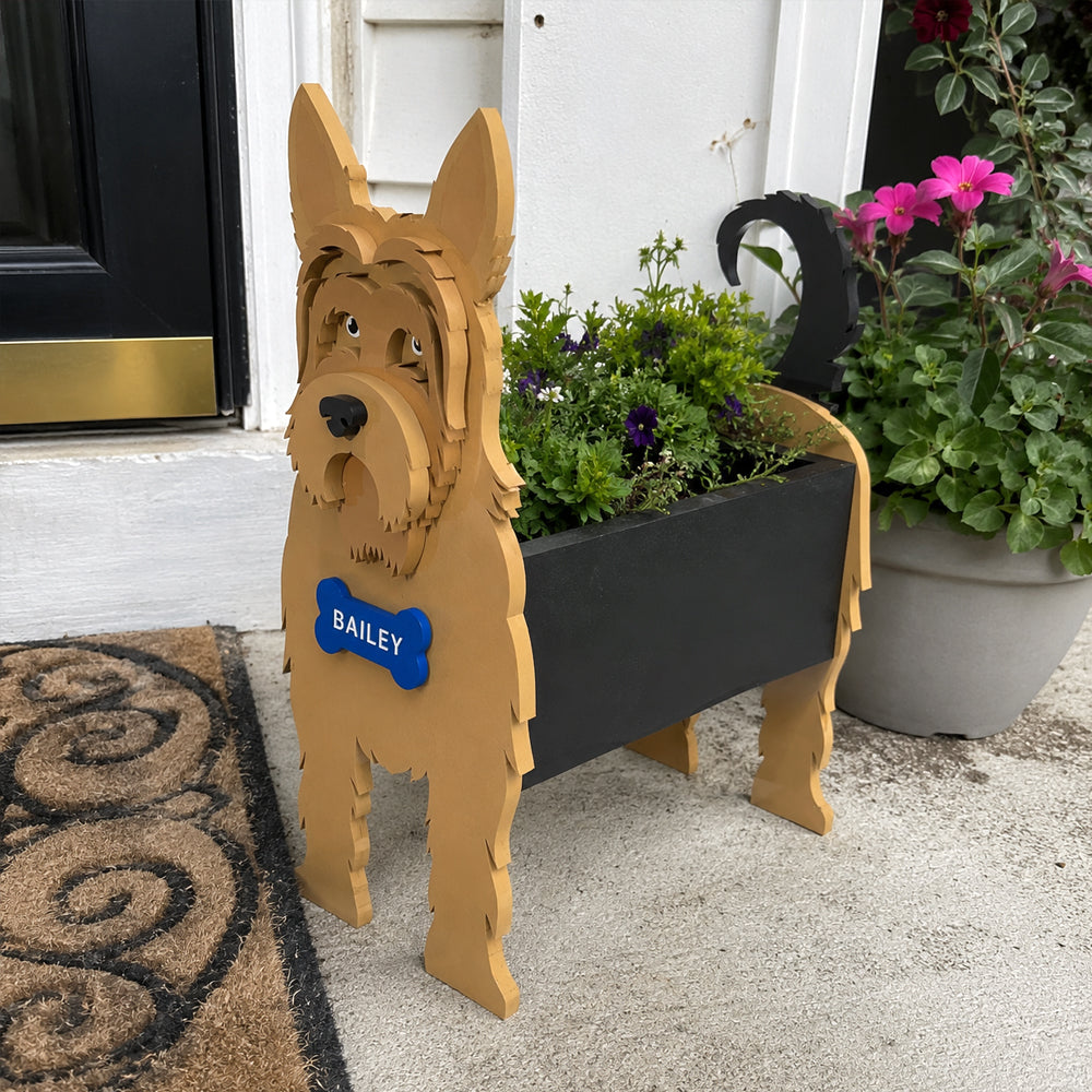 Yorkshire Terrier dog planter filled with fresh flowers is placed in the garden
