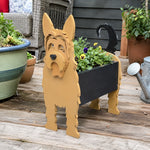 Yorkshire Terrier dog planter filled with fresh flowers is placed in the garden