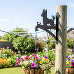 Yorkshire terrier metal hanging basket bracket mounted on outdoor wall for plant decoration