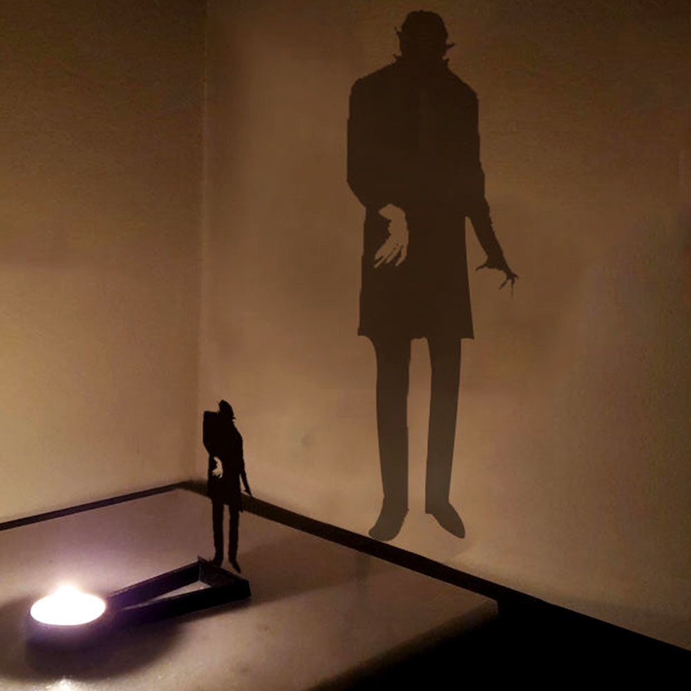 Zombie halloween metal candle holder casting a spooky shadow on the wall
